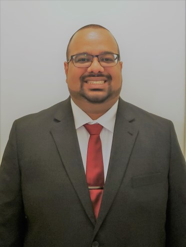 man in black suite smiling